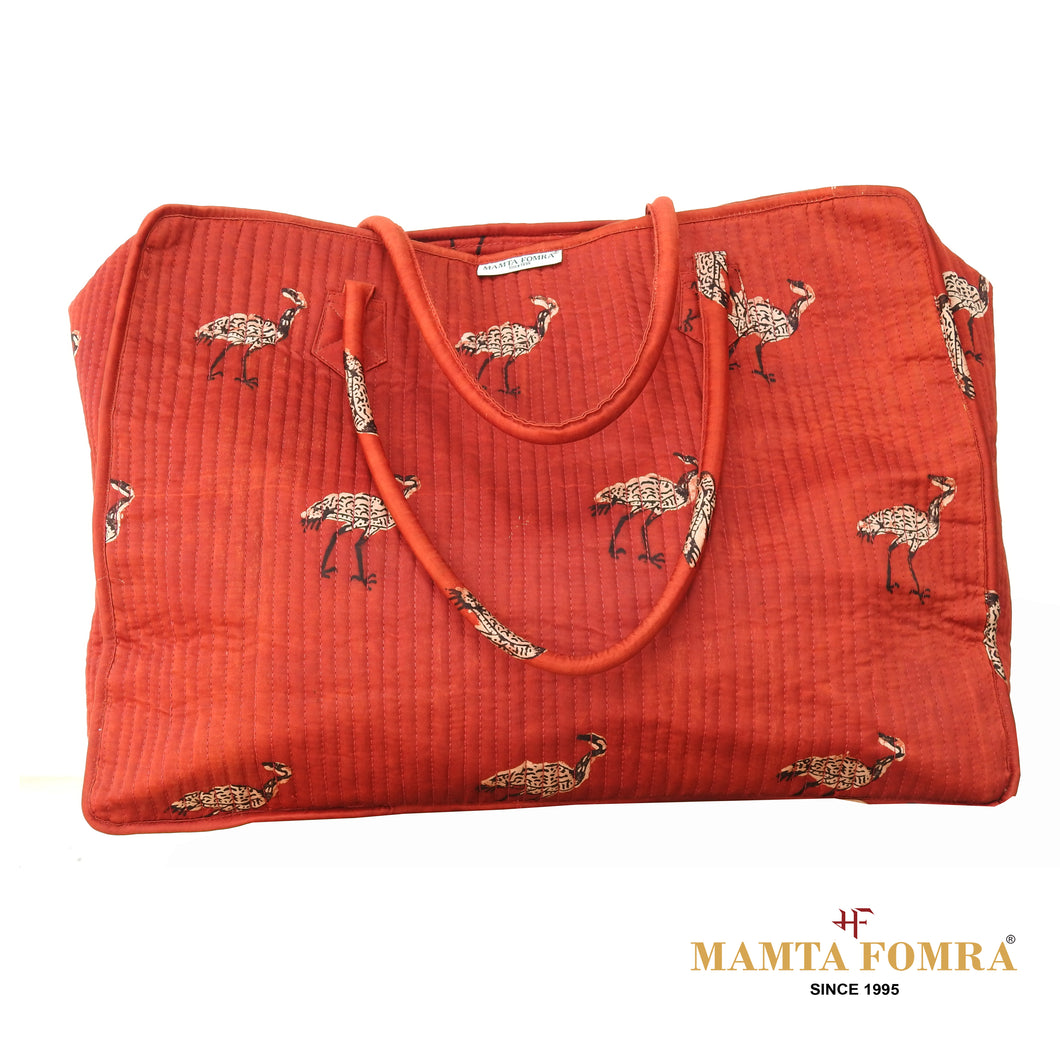 Rust-red fabric with a charming crane bird print bag